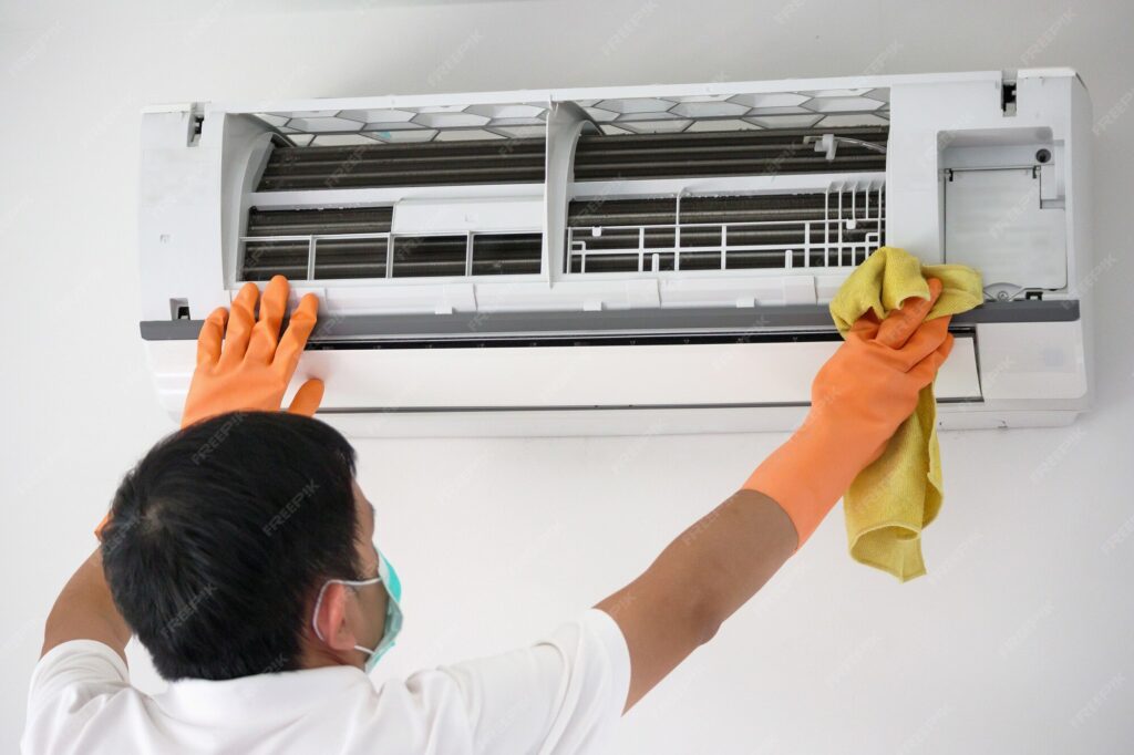 asian man cleaning air conditioner with microfiber cloth 293060 397